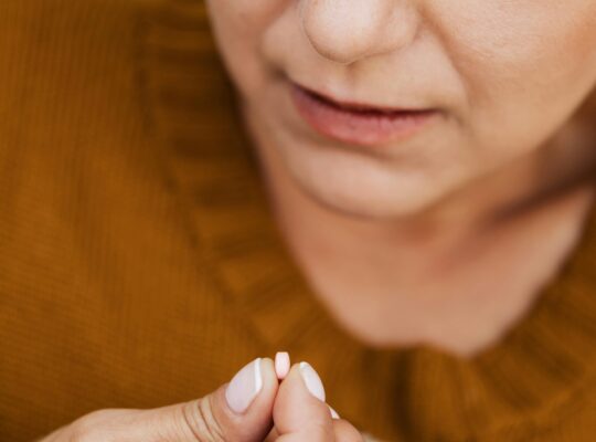 Persona tomando medicamento en casa siguiendo tratamiento
